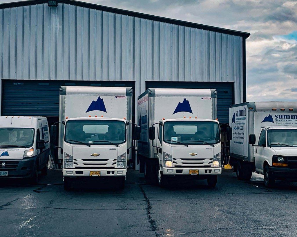 Summit Cleaning & Restoration box trucks and vans parked at the Stayton shop
