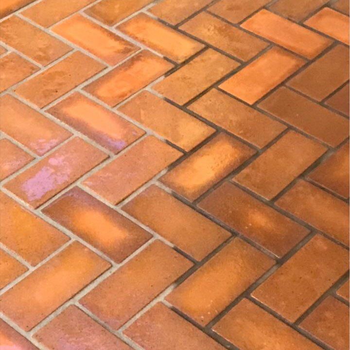 Herringbone ceramic tile floor after professional cleaning