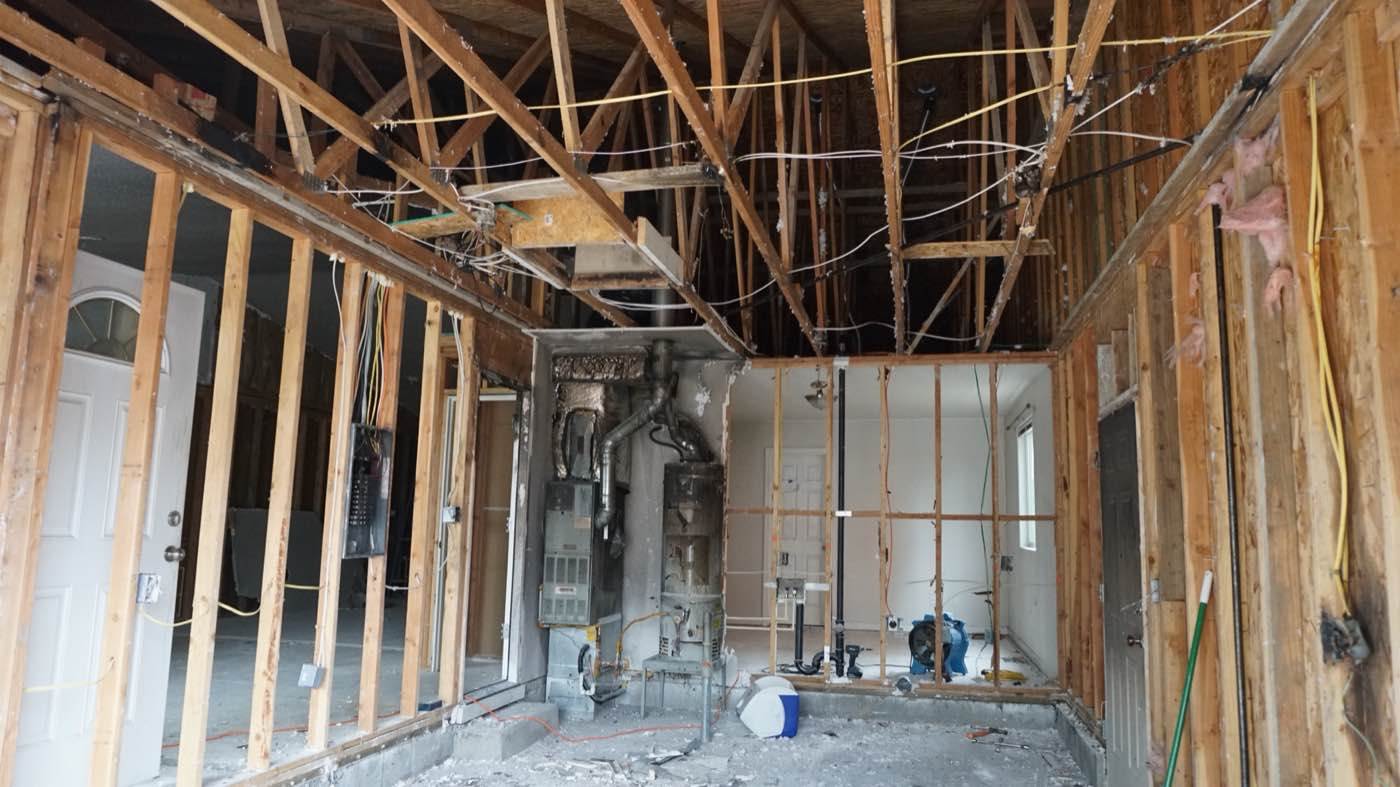Fire-damaged interior stripped to framing during restoration