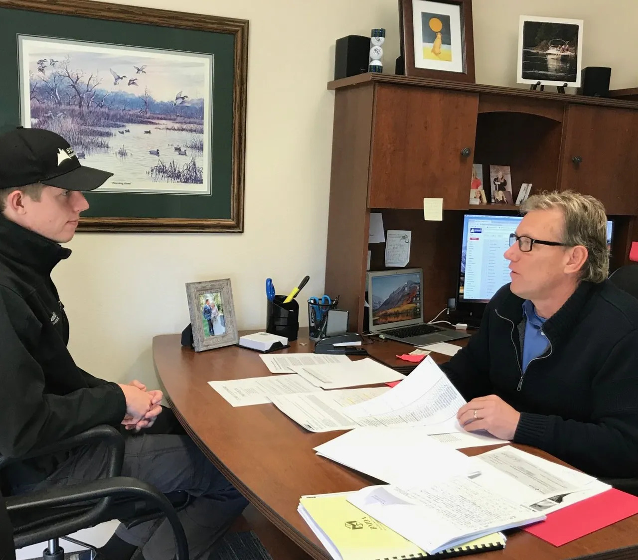 Summit staff reviewing insurance paperwork with a customer in the office