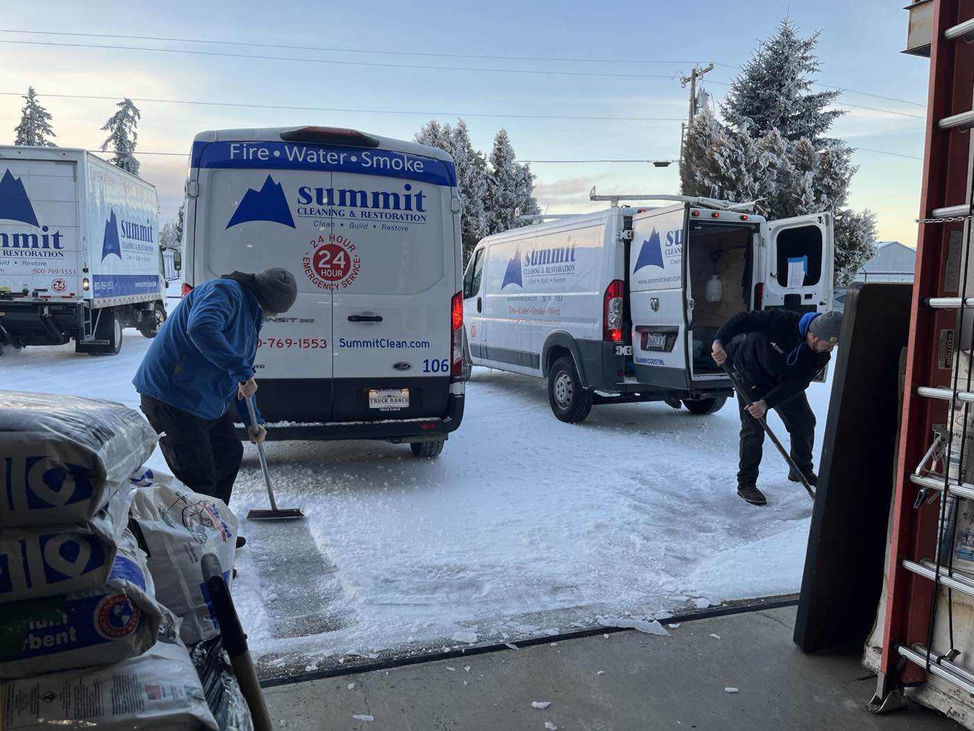 Summit vans and crew working in snow during a winter storm