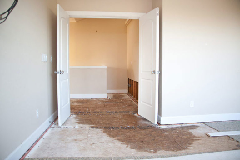Room with flooring removed down to subfloor during water damage drying