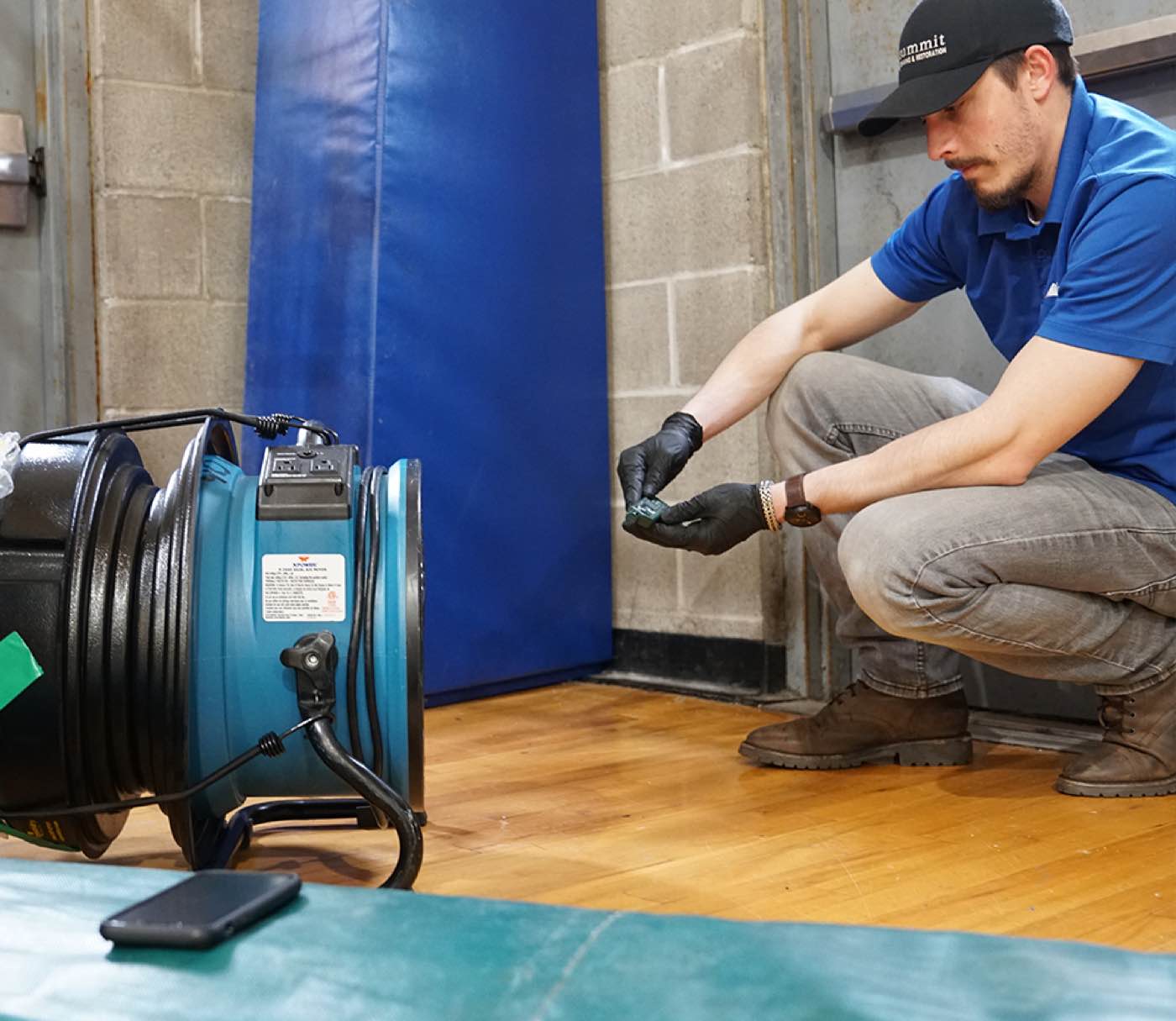 Summit technician setting up drying equipment during an emergency water-intrusion response