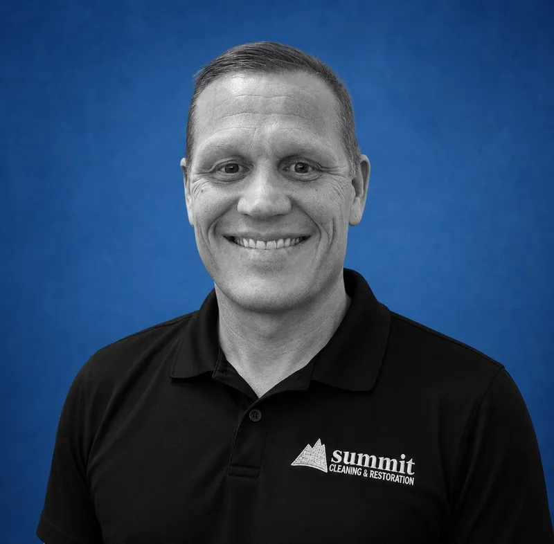 Ryan Hubbard, Director of Operations (Junction City) at Summit Cleaning & Restoration — B&W portrait on Summit cobalt